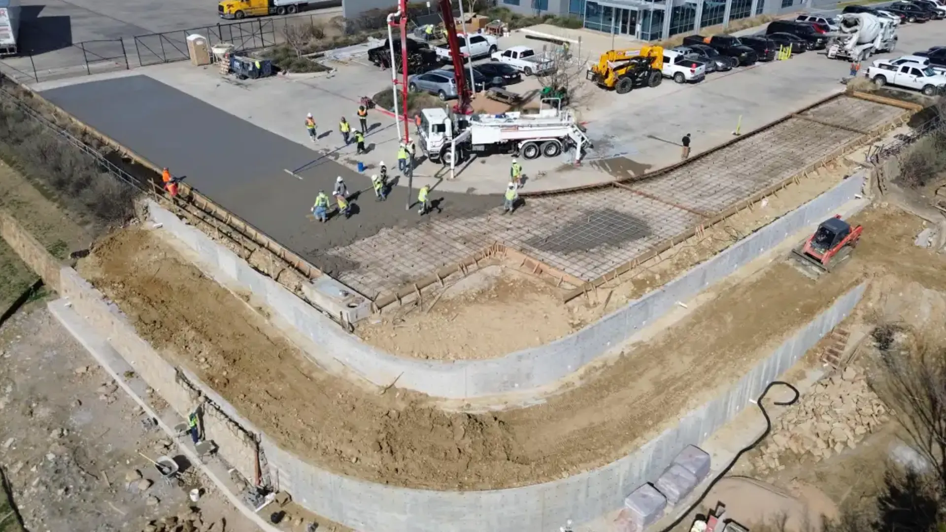 Recent-Project 2 Aerial view of a construction site with workers pouring concrete.